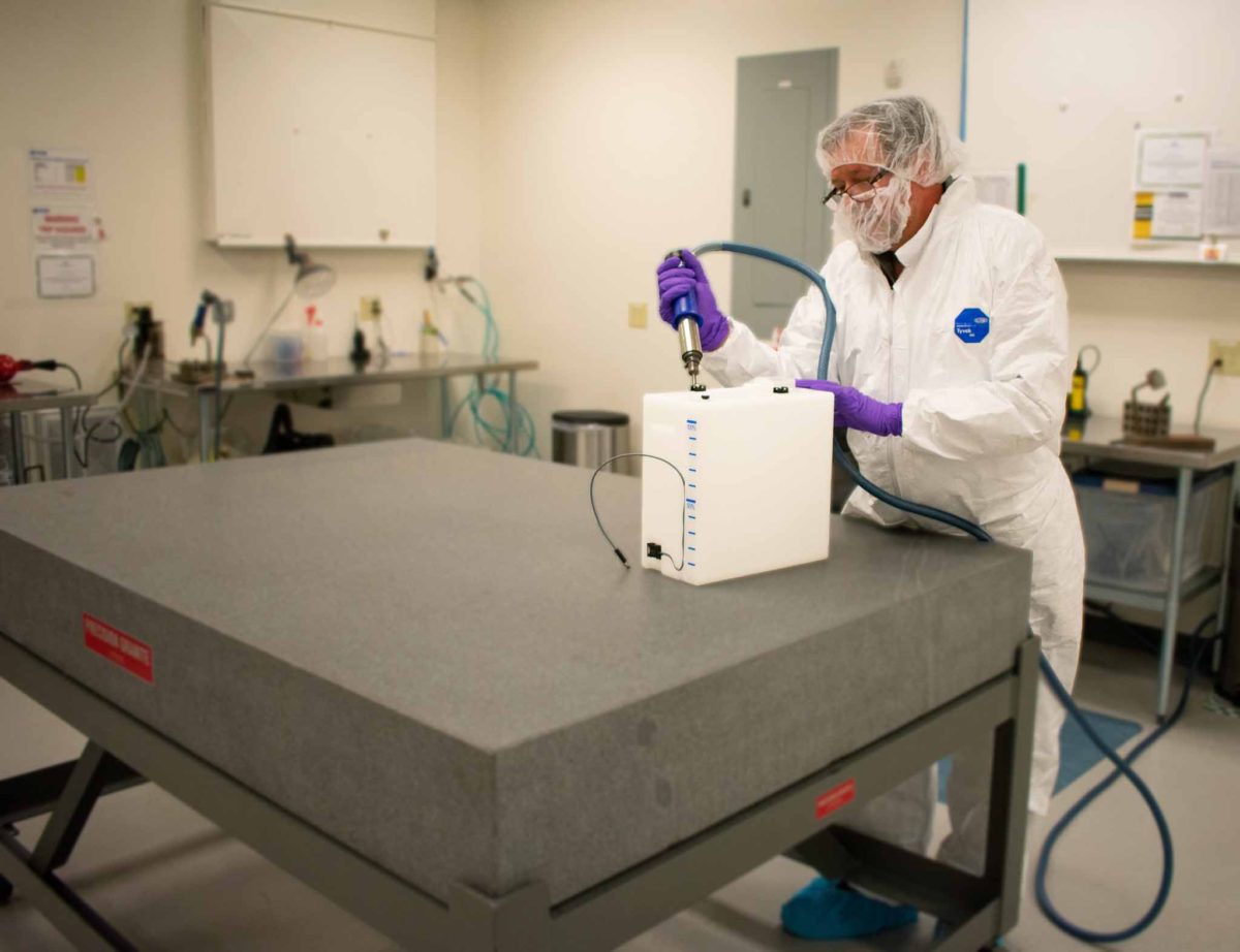 A worker welding a dosing bottle with durable high-purity thermoplastic materials